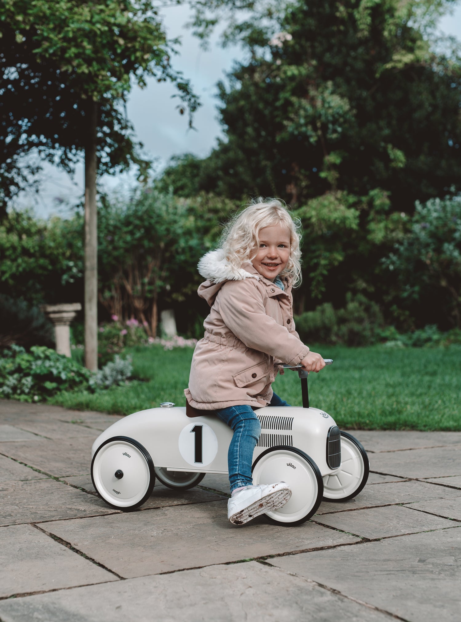 girl riding vilac classic metal racing car ride on
