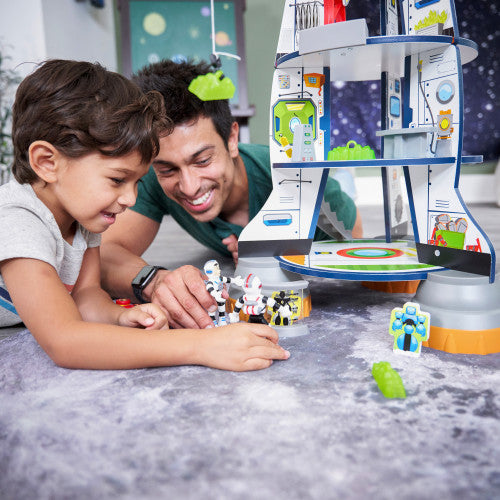 man and boy playing with kidkraft rocket ship playset
