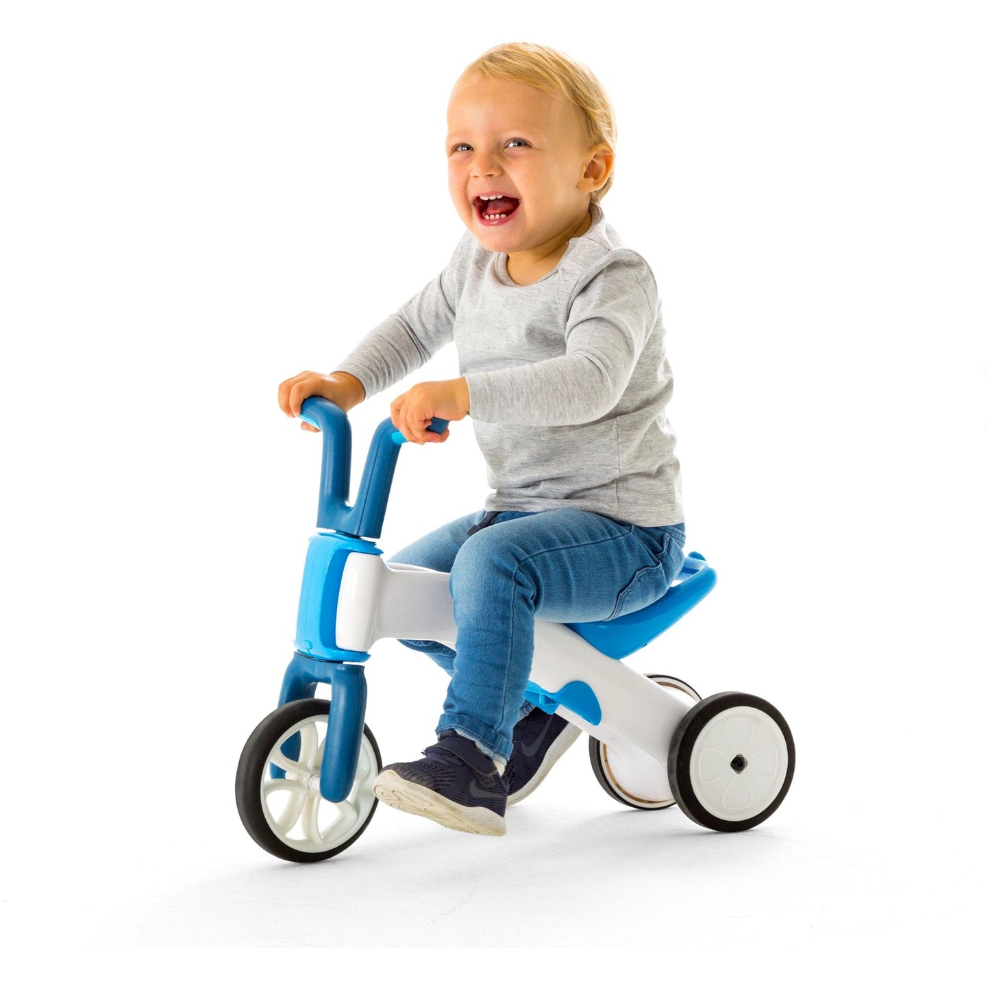 smiling child riding Chillafish BUNZI Trike Blue
