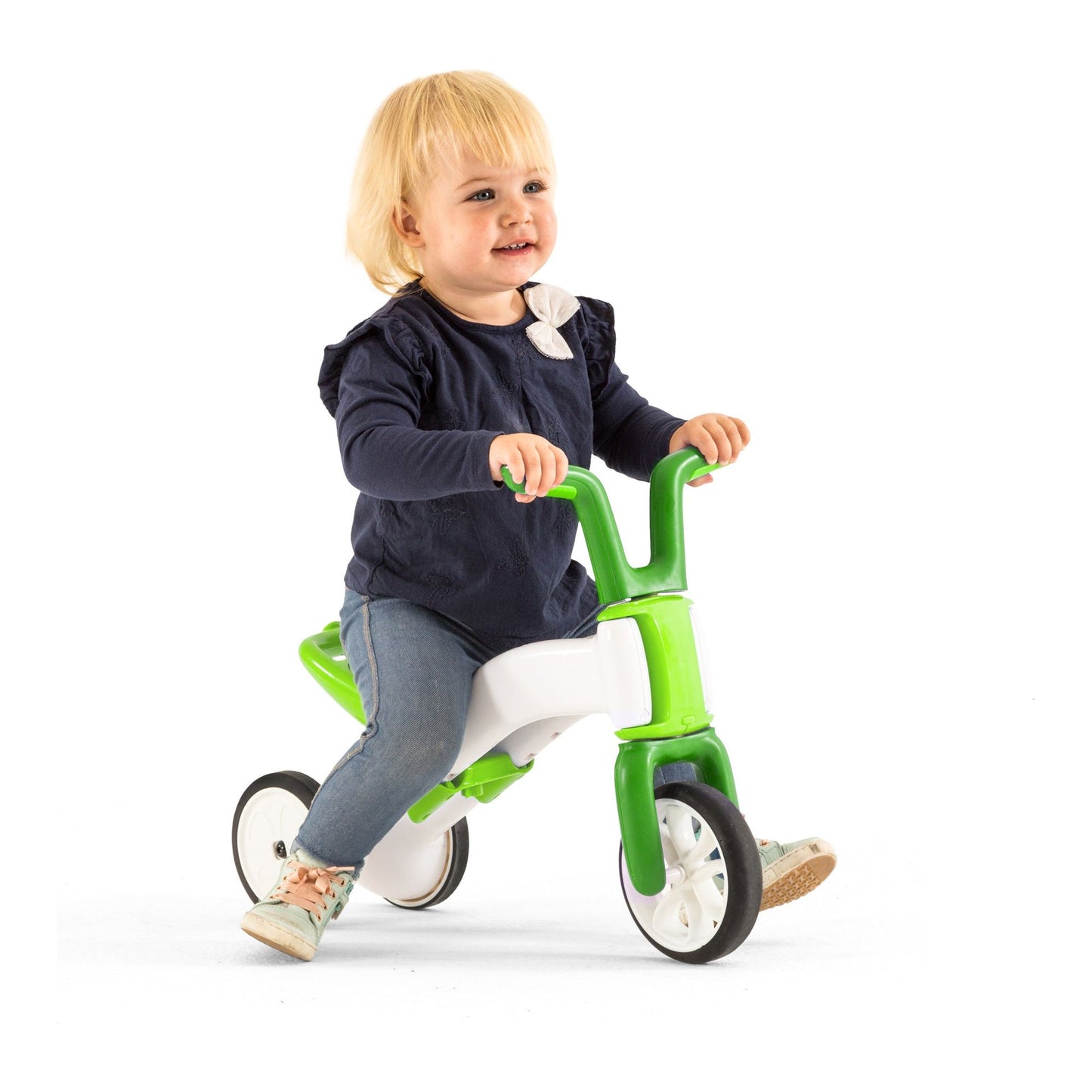 girl straddling Chillafish BUNZI Trike Lime