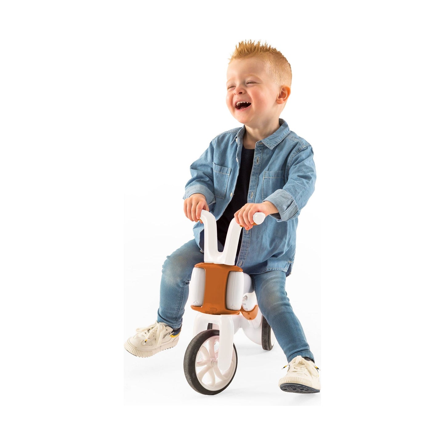 smiling boy riding Chillafish BUNZI Trike Camel