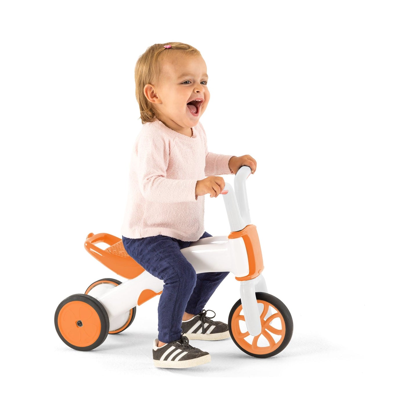 smiling girl riding Chillafish BUNZI Trike Ginger