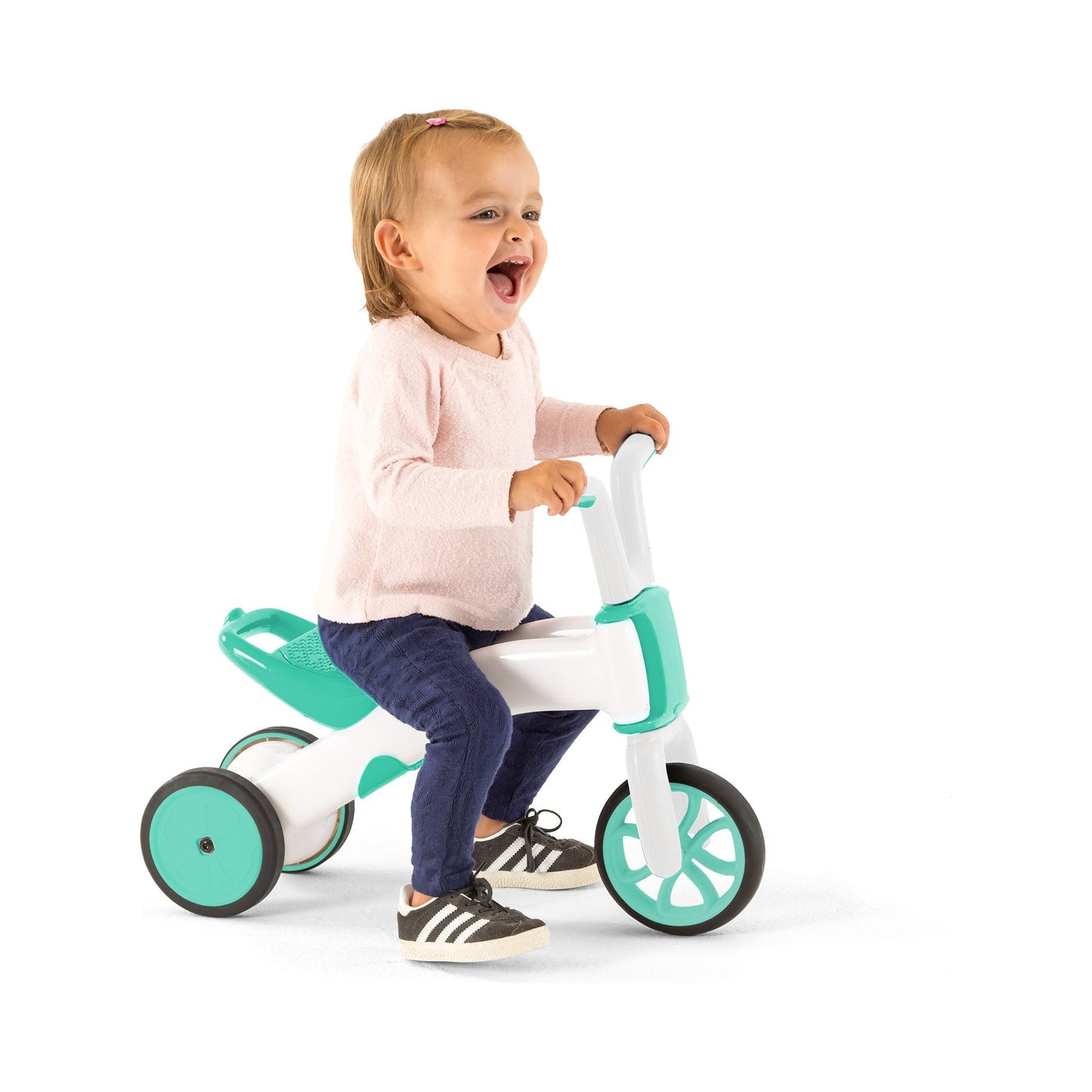 smiling girl riding Chillafish BUNZI Trike Mint