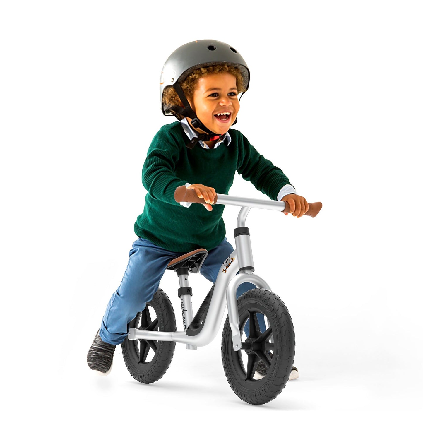 smiling boy riding Chillafish Balance Bike Charlie Silver