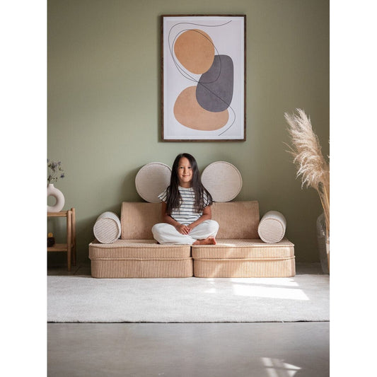 girl sitting on Wigiwama Brown Sugar Settee in lounge