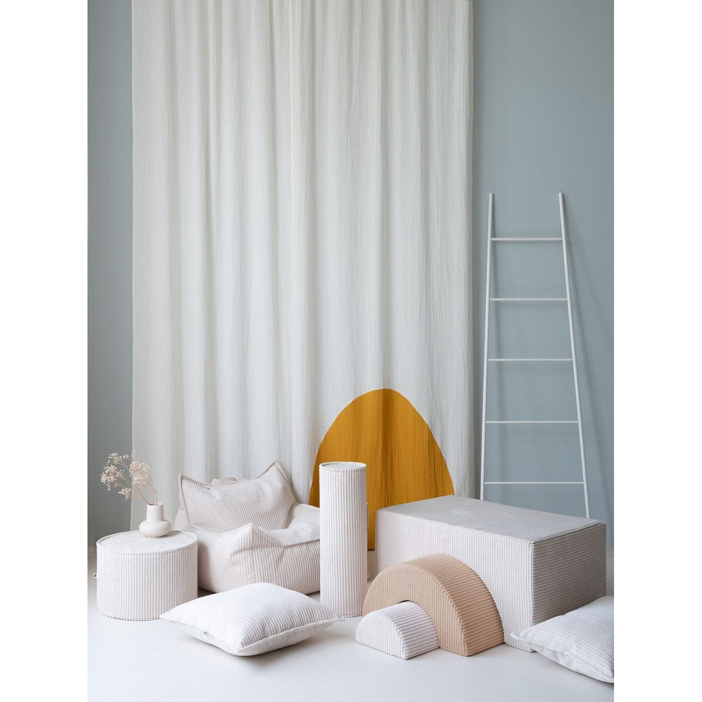 Wigiwama Marshmallow Pouffe next to beanbag chair, softplay set and kids furniture cushion
