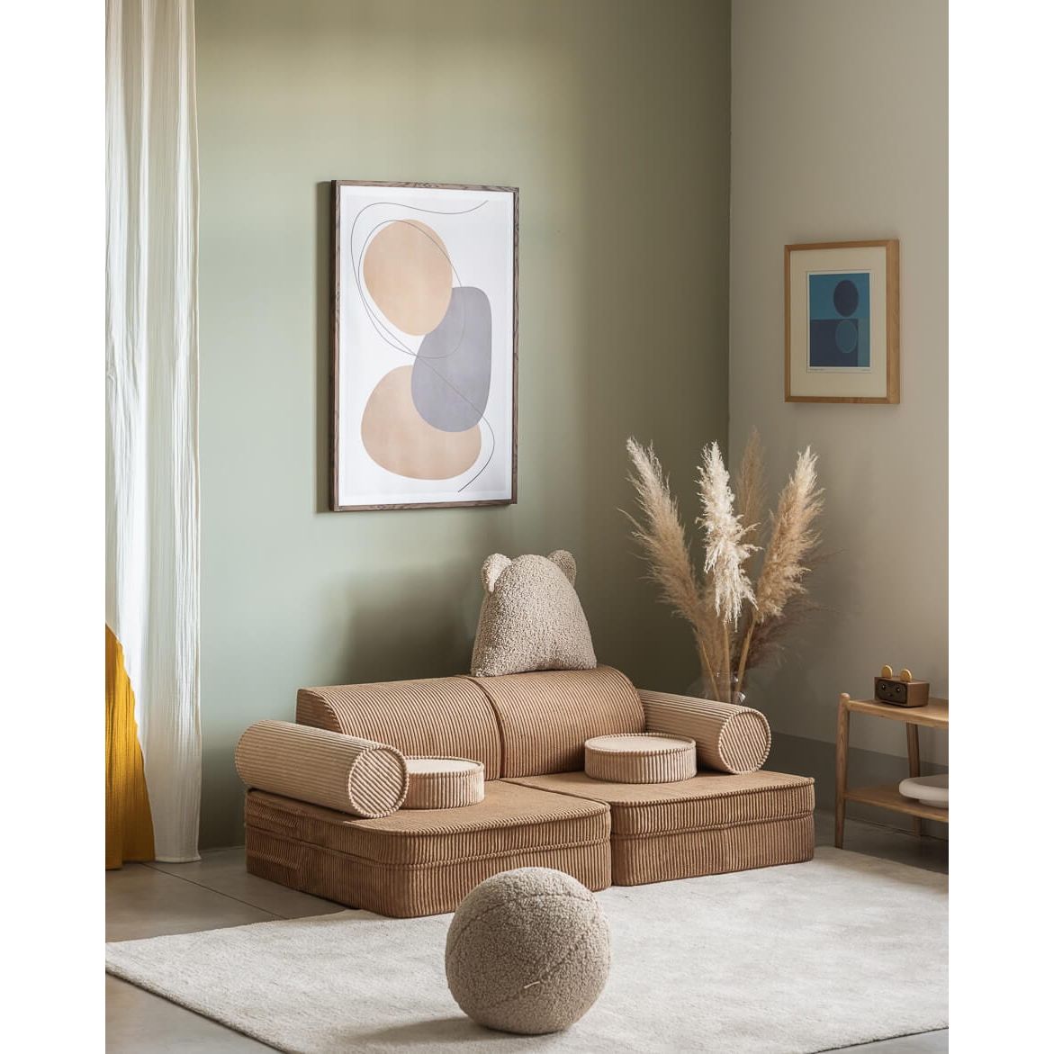 Wigiwama Toffee Settee front right in lounge in front of wall art