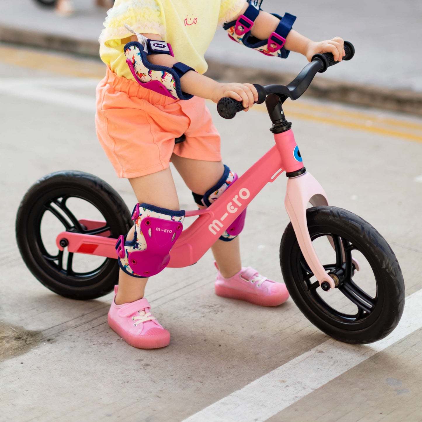 child riding Micro Scooter Balance Bike Lite Pink