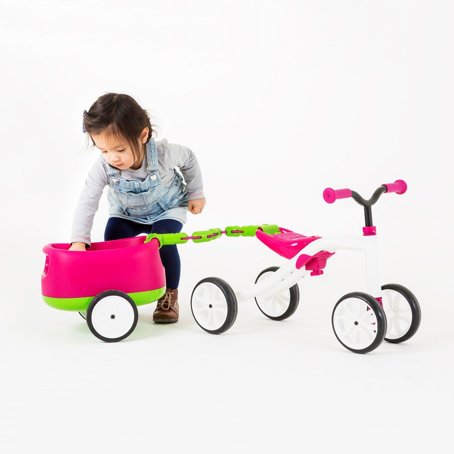 girl reaching into Chillafish Quadie and Trailie Ride-On Pink