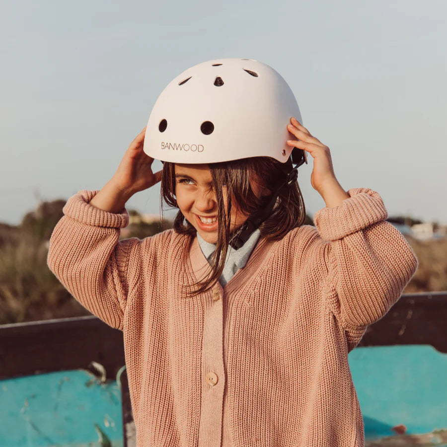 smiling girl wearing banwood kids bike hedlmet in white