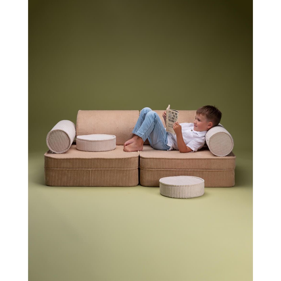 boy lying on Wigiwama Brown Sugar Settee reading book