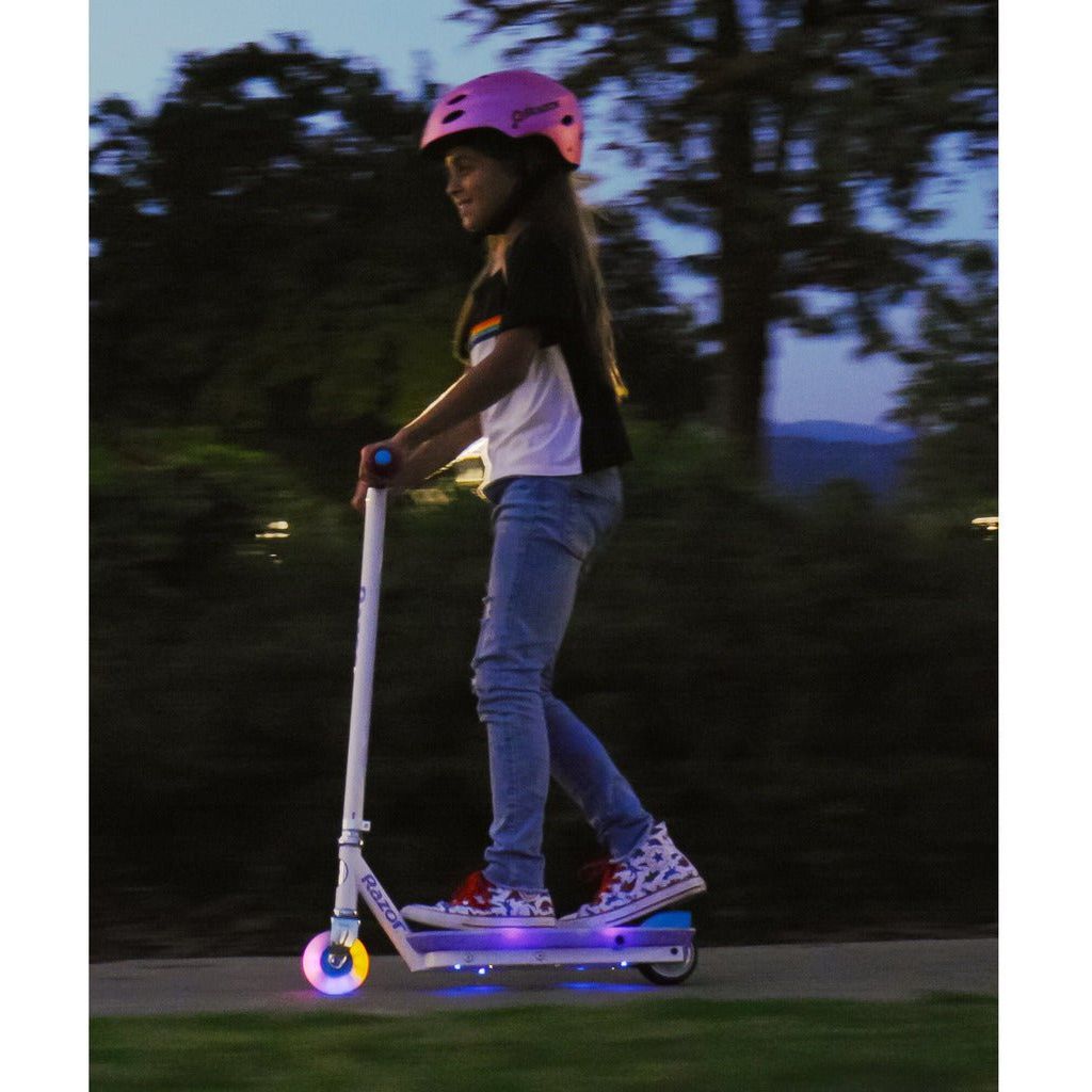 girl riding Razor Electric Party Pop 10.8V Lithium-ion Scooter with lights on