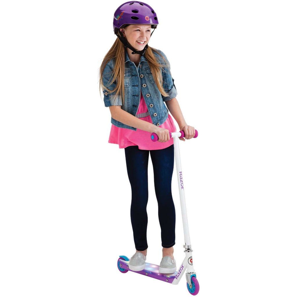 girl in helmet standing on Razor Electric Party Pop 10.8V Lithium-ion Scooter