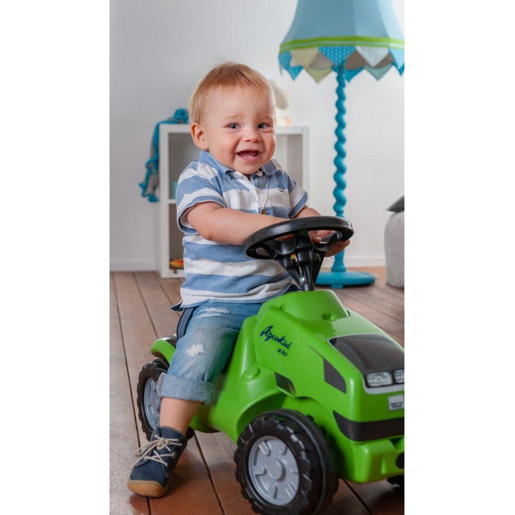 boy riding Rolly Toys John Deere 6150R Mini Trac With Opening Bonnet front right