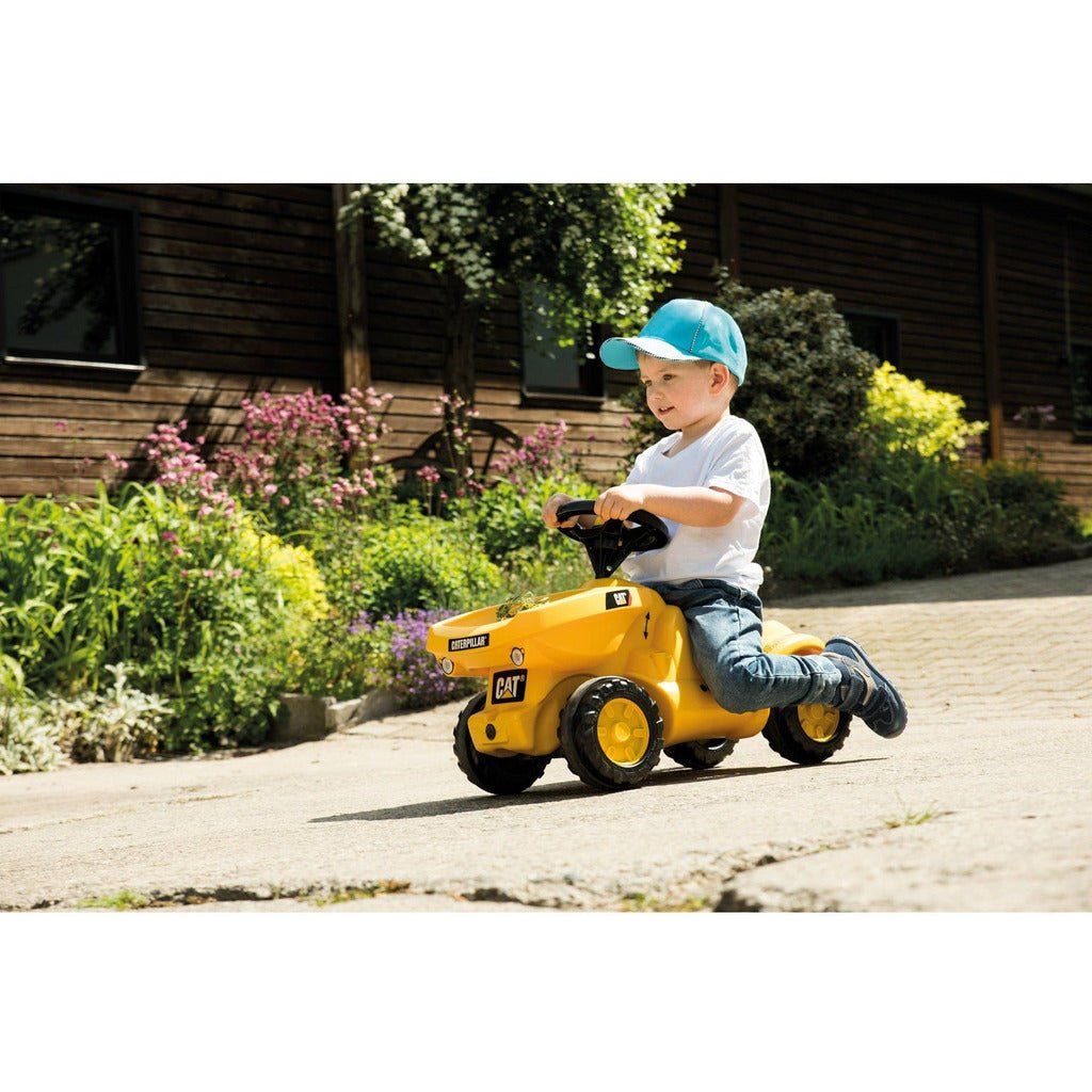 boy riding Rolly Toys Caterpillar Dumper Mini Trac With Tipping Dumper