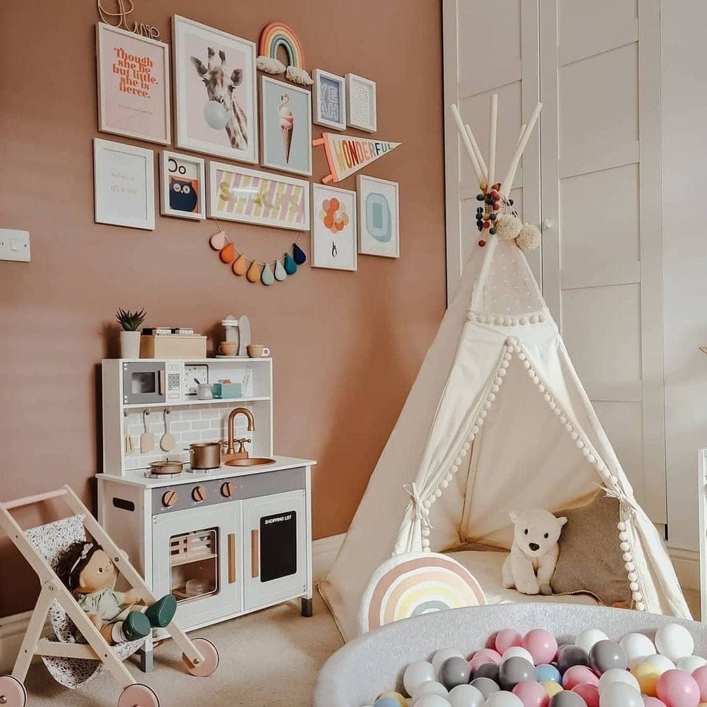 MINICAMP Original Play Tent With Pompoms in playroom next to role play kitchen