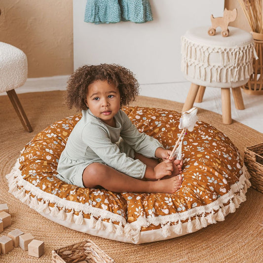girl sitting on MINICAMP Kids Floor Cushion Seating Pouffe in Plant Pattern