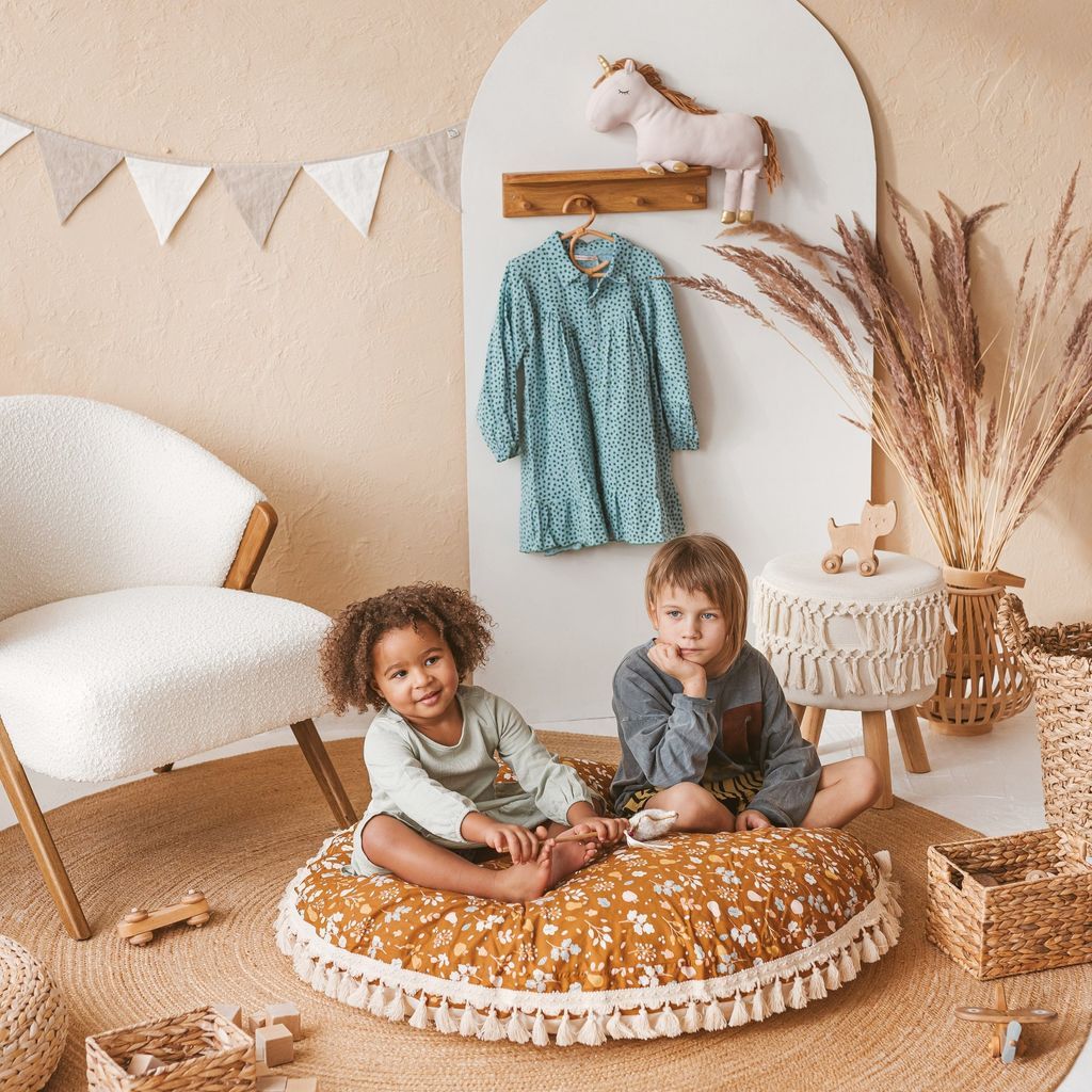 2 girls sitting on MINICAMP Kids Floor Cushion Seating Pouffe in Plant Pattern in lounge