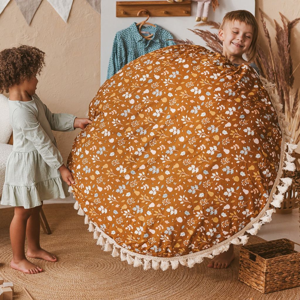 2 girls carrying MINICAMP Kids Floor Cushion Seating Pouffe in Plant Pattern