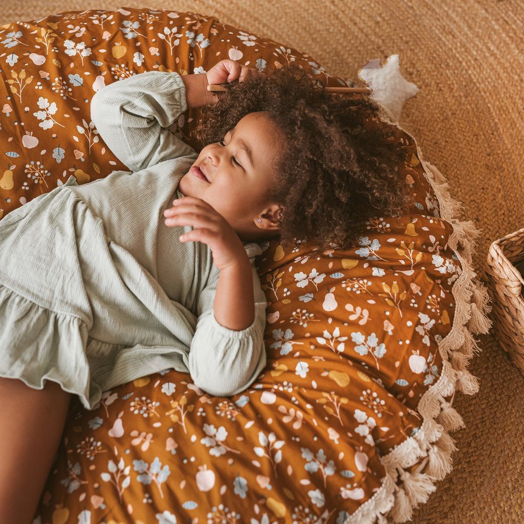 girl lying on MINICAMP Kids Floor Cushion Seating Pouffe in Plant Pattern