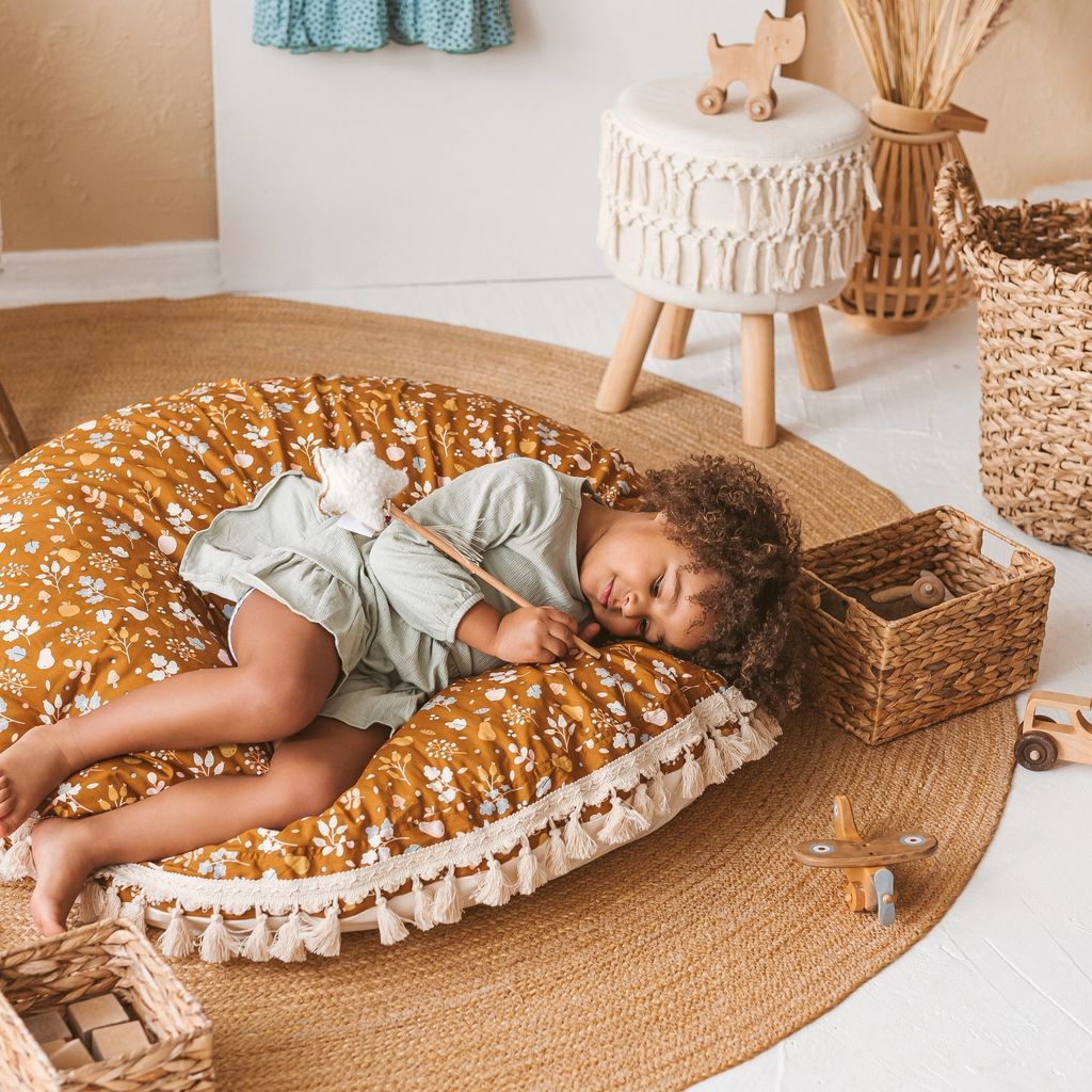 girl lying on her side on MINICAMP Kids Floor Cushion Seating Pouffe in Plant Pattern