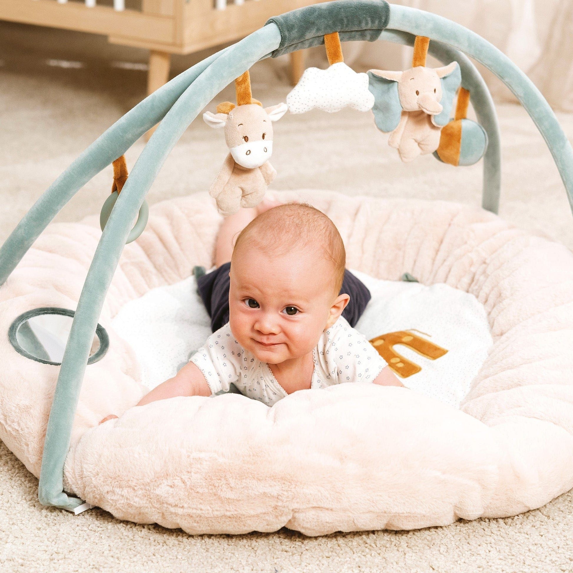 baby lying on tummy on Nattou Baby Stuffed Playmat - Luna and Axel