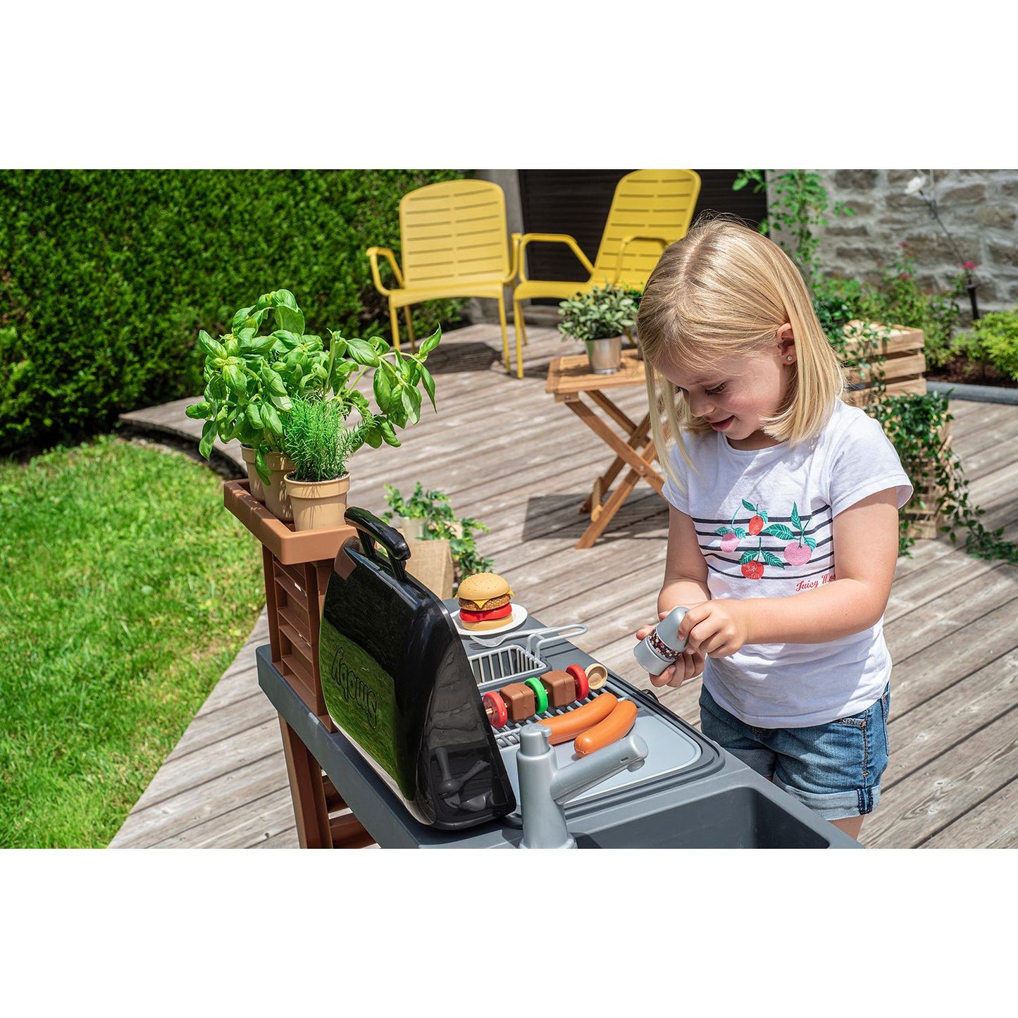 girl cooking on Smoby Garden Kitchen BBQ Set