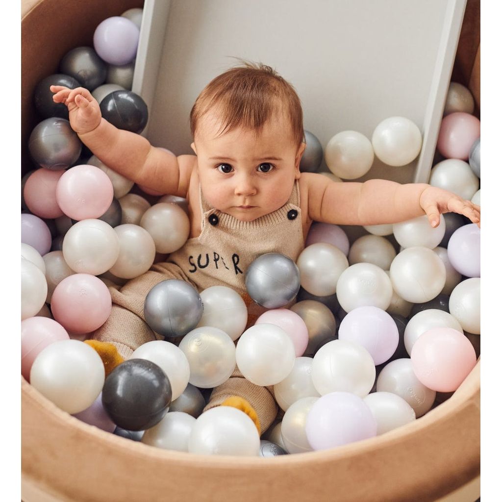 boy sittting in Misioo Velvet Ball Pit Gold with 200 Balls
