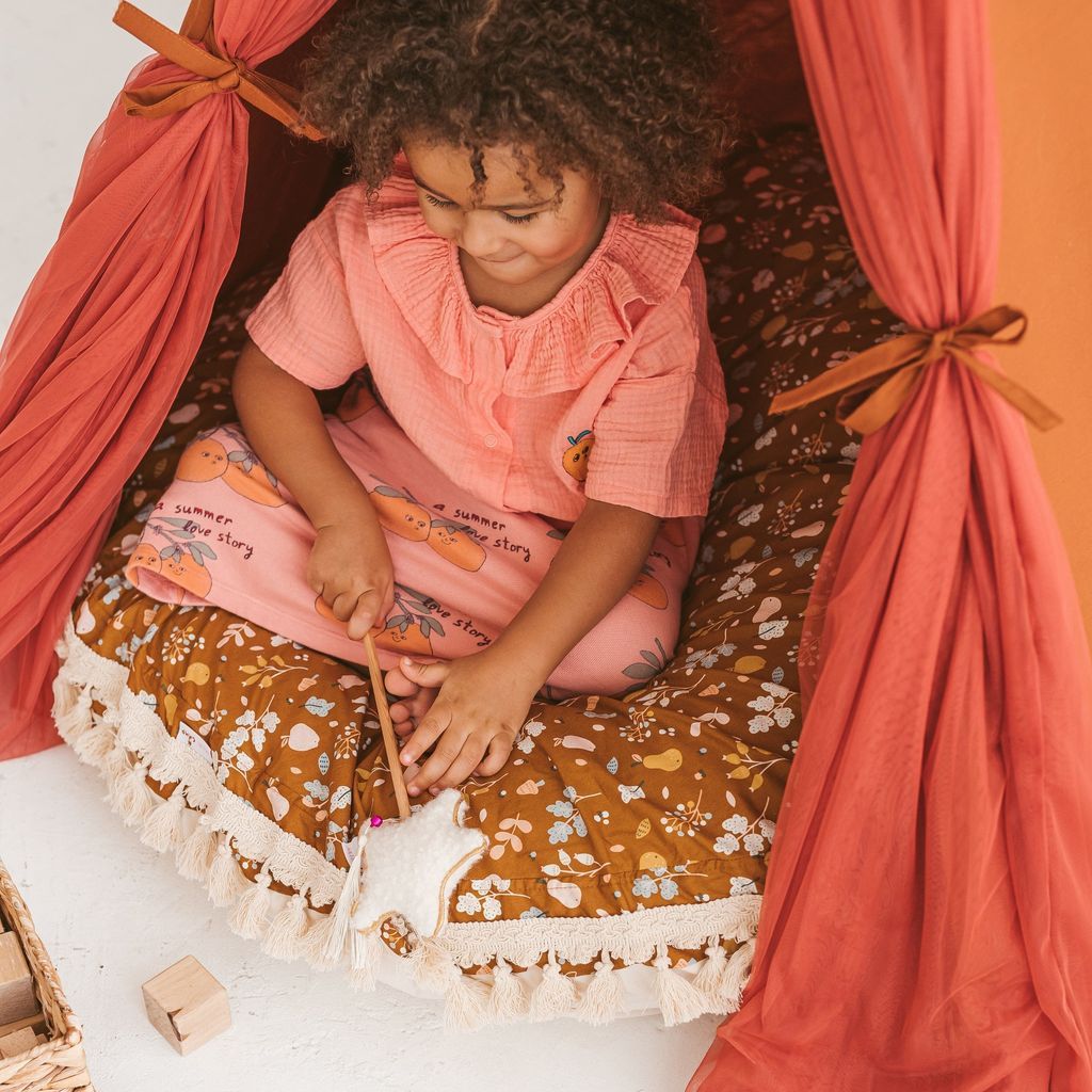 girl sitting on MINICAMP Kids Floor Cushion Seating Pouffe in Plant Pattern in Kids play tent