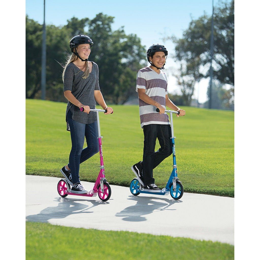 boy and girl riding Razor A5 LUX scooters in blue and pink in park