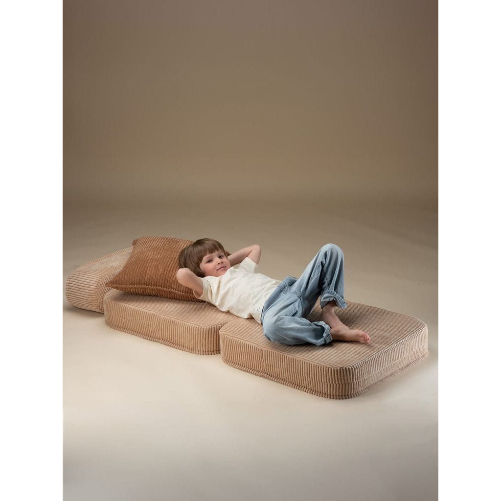 girl with hands behind head lying on Wigiwama Brown Sugar Flip Chair