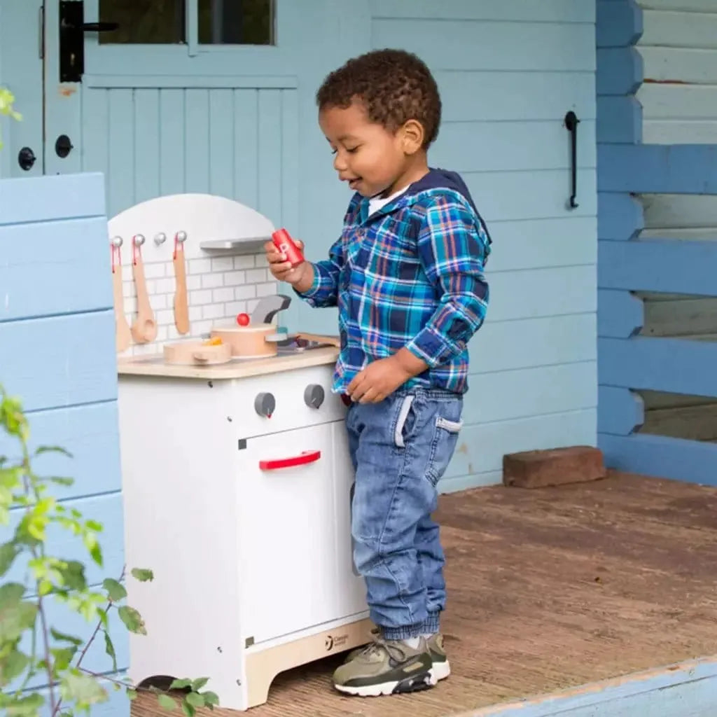 little boy playing with Classic World Wooden Chef's Kitchen Set