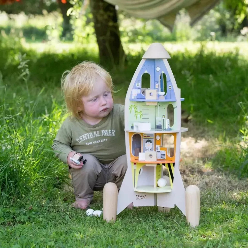 chikd playing with Classic World Wooden Rocket Ship