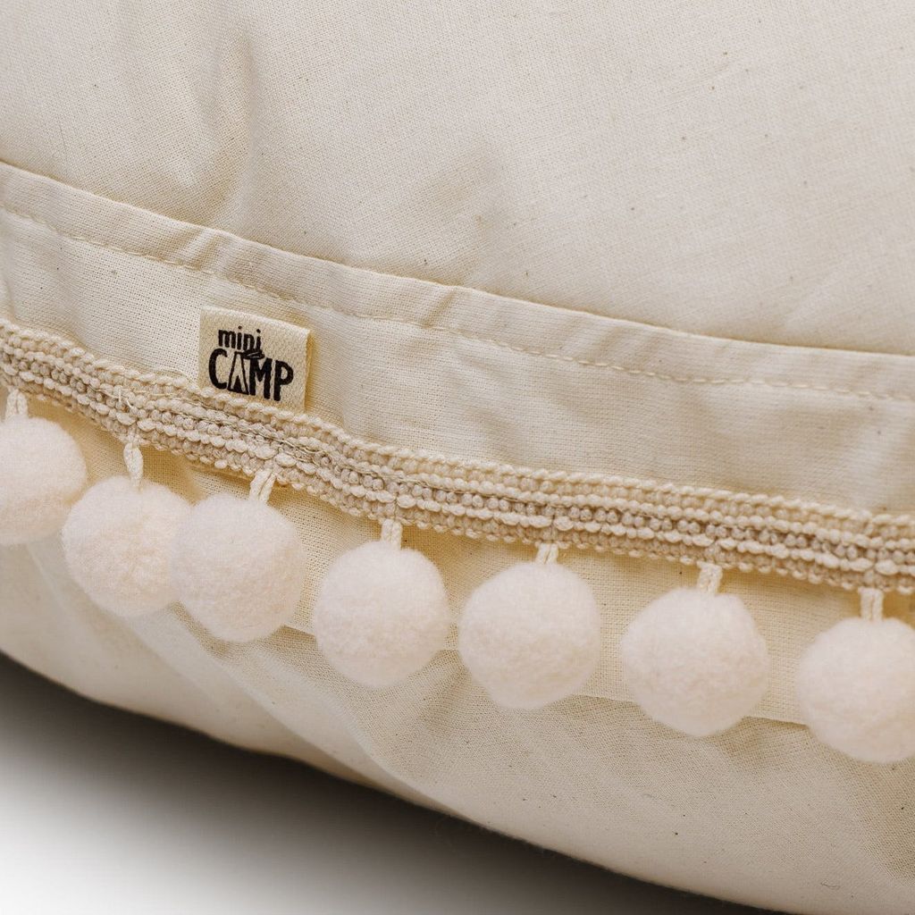 close up of MINICAMP Large Floor Cushion With Pom Poms