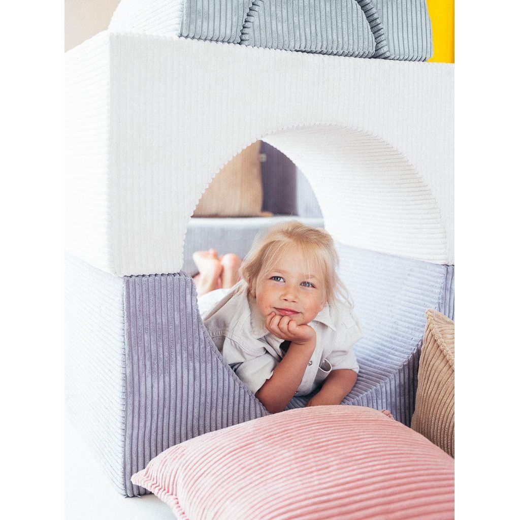 girl lying in softplay set