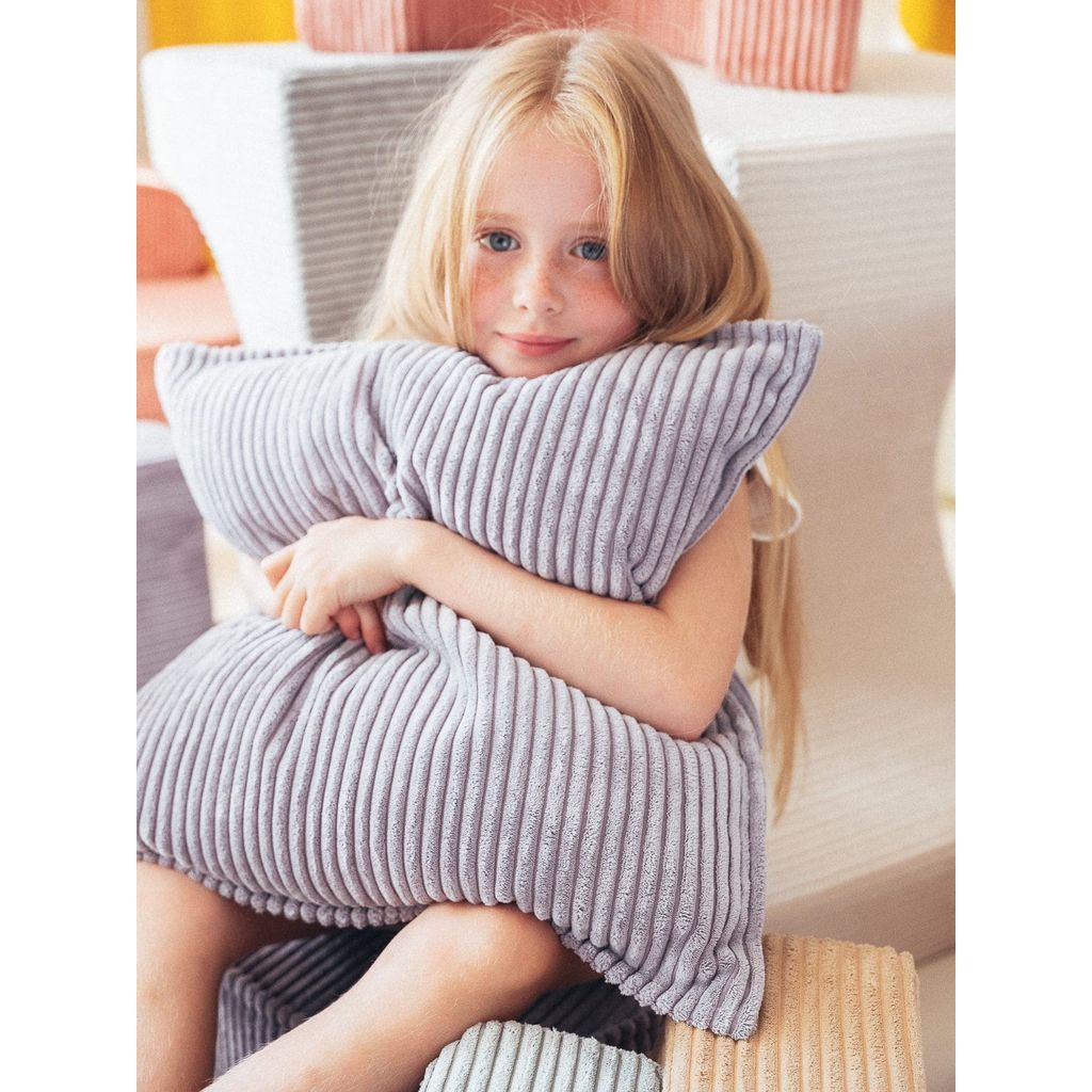 girl cuddling Wigiwama Blueberry Blue Block Cushion