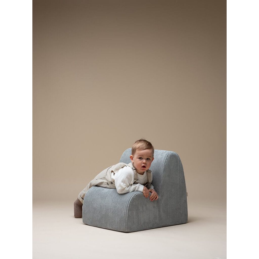 boy lying across Wigiwama Peppermint Green Kids Cloud Chair