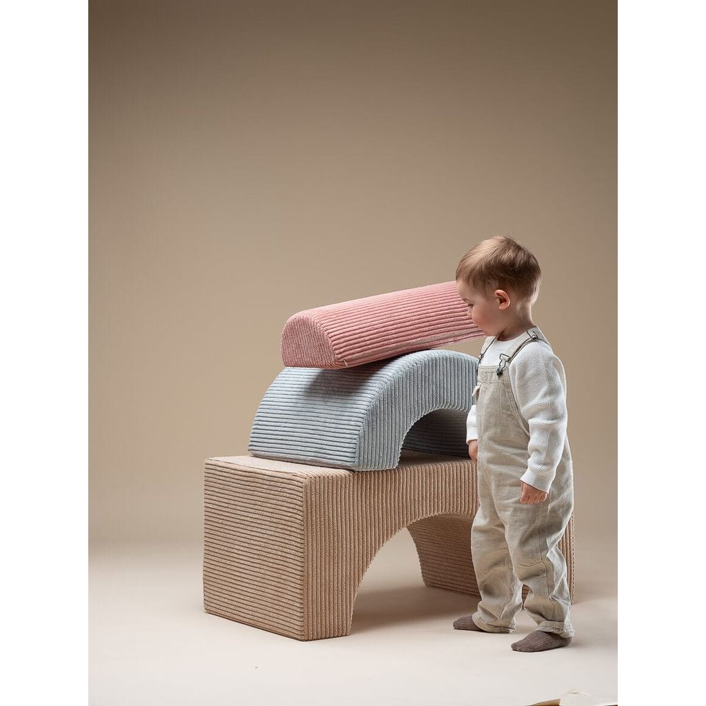 boy standing in front of Wigiwama Brown Sugar Rainbow Playset
