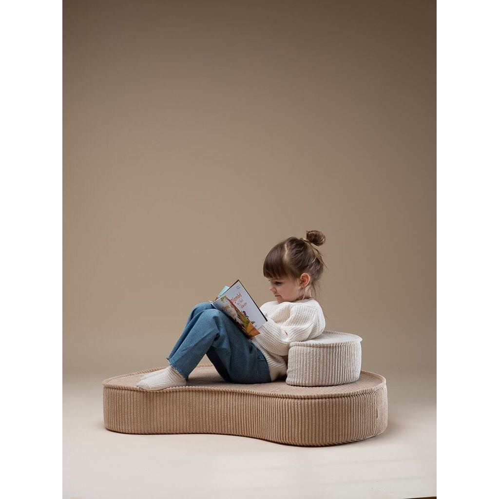 girl reading book while sitting on Wigiwama Brown Sugar Lounge Chair