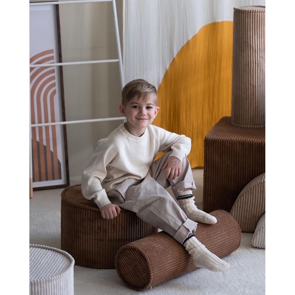 boy sitting on Wigiwama Toffee Pouffe
