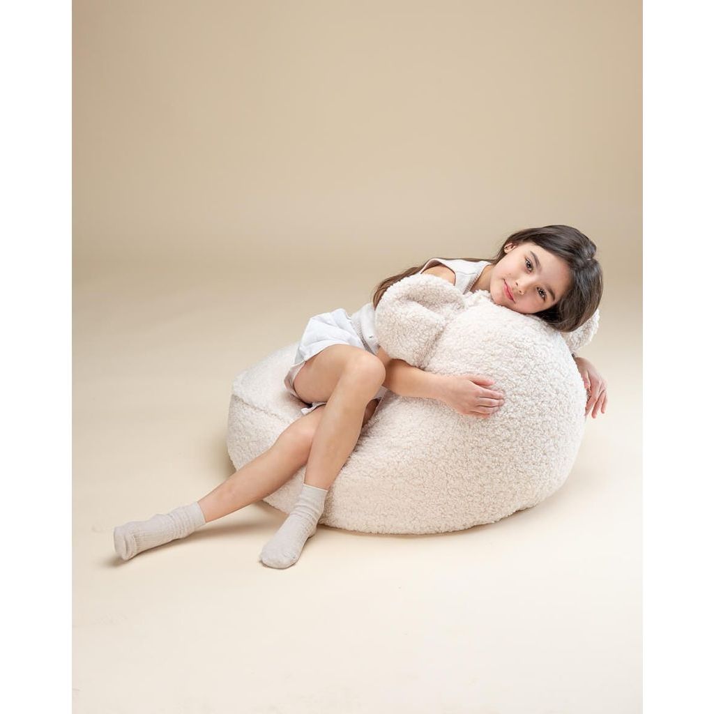 girl lying on Wigiwama Cream White Bear Beanbag