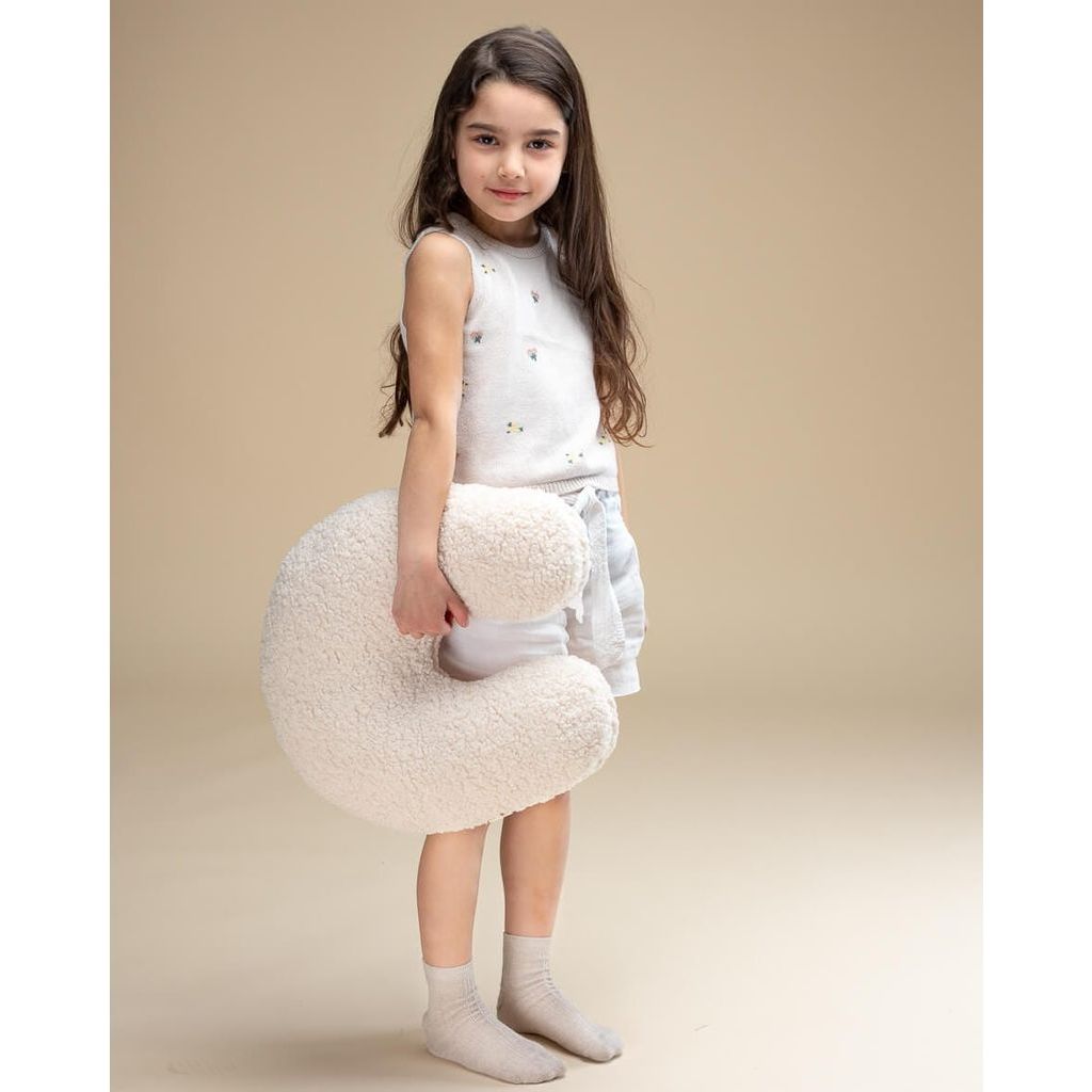girl holding Wigiwama Cream White U Pillow
