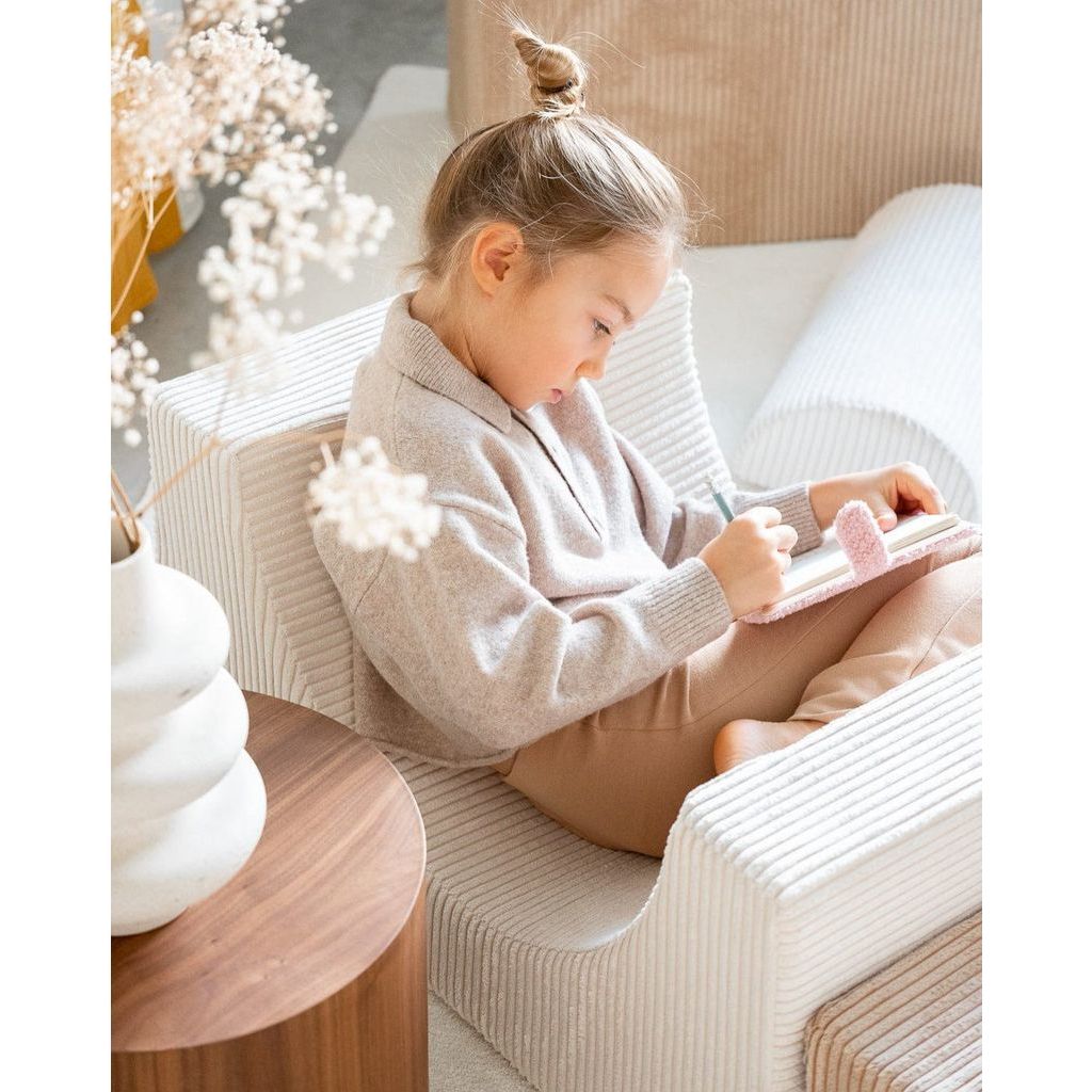 girl curled up in Wigiwama Marshmallow Rainbow softplay set