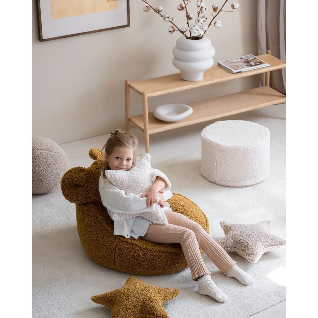 girl sitting on Wigiwama Maple Bear Beanbag holding cushion