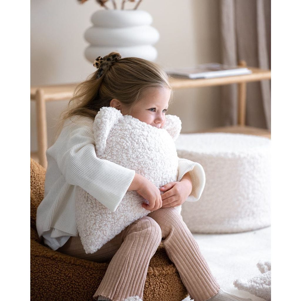 girl clutching Wigiwama Cream White Bear Cushion