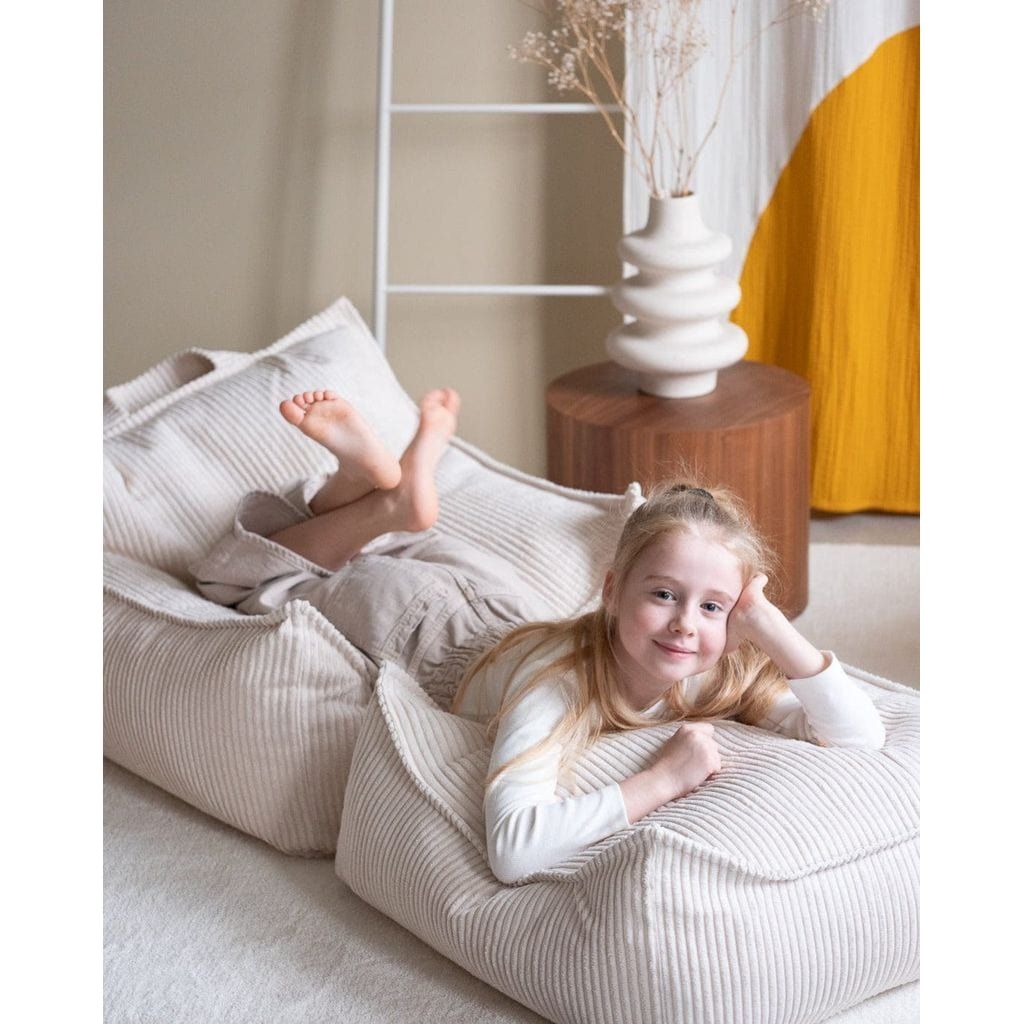 girl lying on kids beanbag chair and Wigiwama Marshmallow Square Ottoman