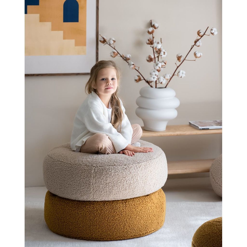girl sitting on Wigiwama Maple Ottoman