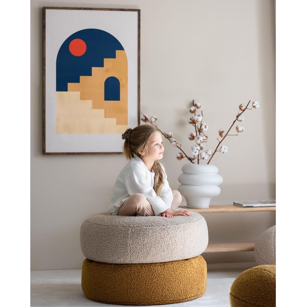 girl sitting on stacked Wigiwama Maple Ottoman cushions