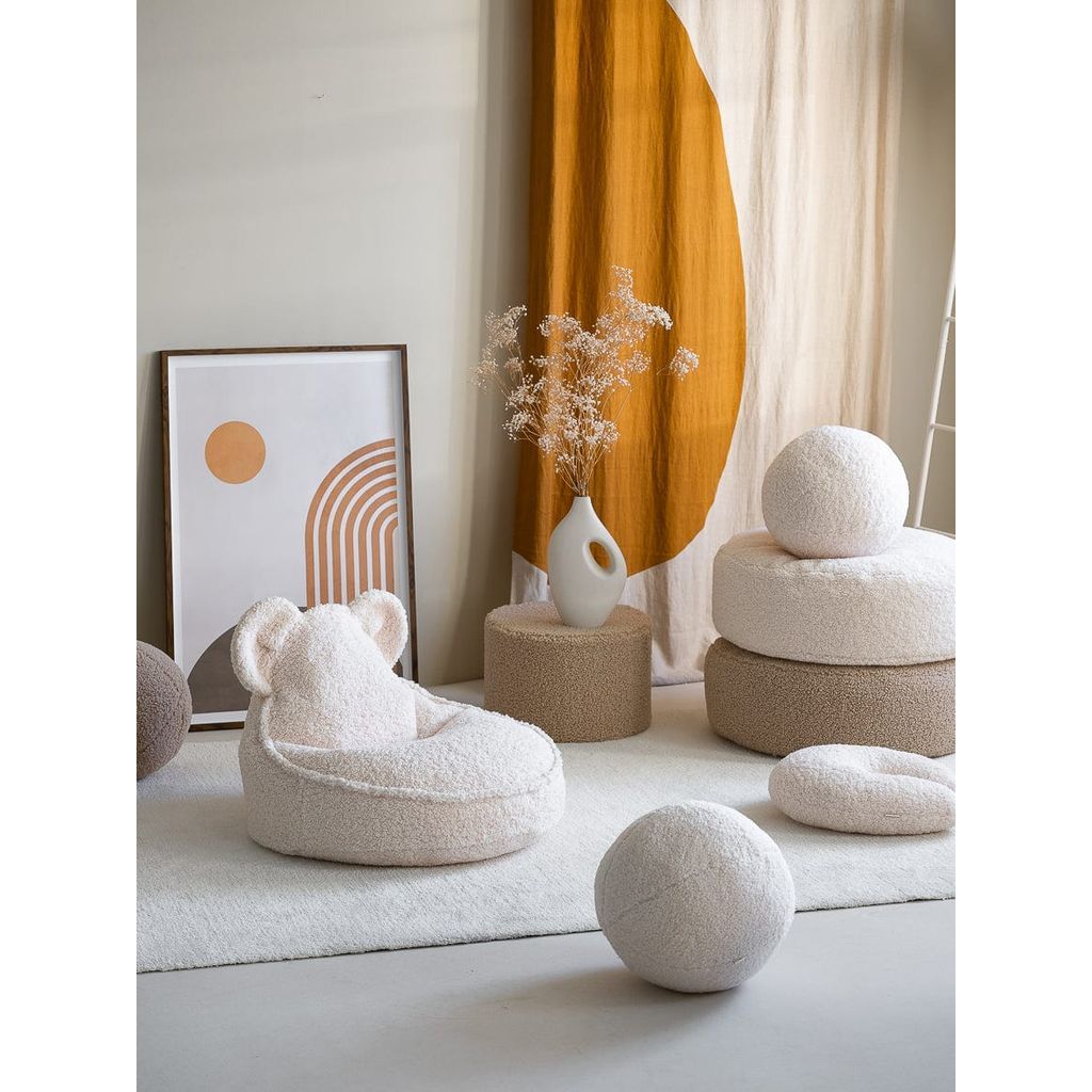 Wigiwama Cream White Ottoman with ball cushion on top next to near cushion