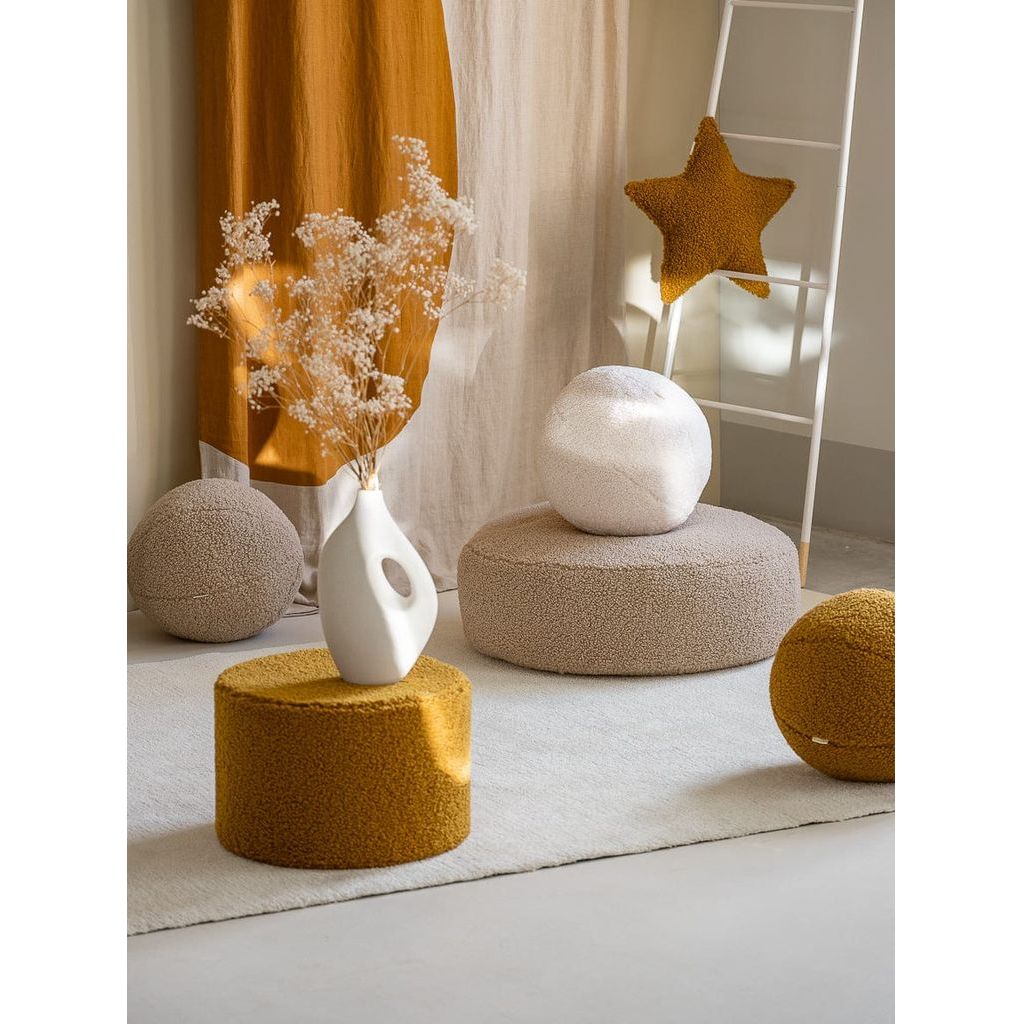 Wigiwama Maple Star Cushion behind ottoman and ball cushion
